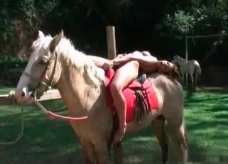 Redhead hottie is sitting naked on her stallion
