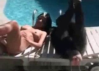 Babe and her monkey lying naked on poolside