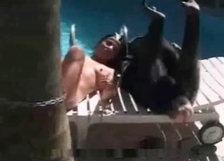 Babe and her monkey lying naked on poolside